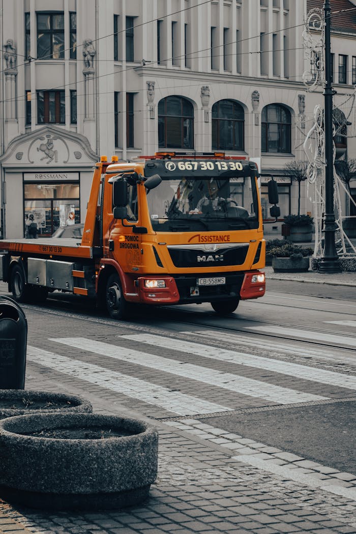 Tow truck driving on a pedestrian lane in downtown Bydgoszcz, Poland.